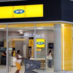 A shopper walks past an MTN shop at mall in Johannesburg