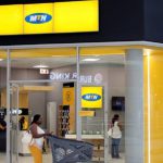 A shopper walks past an MTN shop at mall in Johannesburg