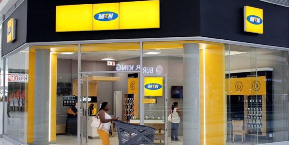 A shopper walks past an MTN shop at mall in Johannesburg