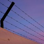 Fence wall with metal cables with spikes