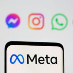 FILE PHOTO: The Meta logo is seen on smartphone in front of displayed logo of Facebook, Messenger, Instagram, WhatsApp, Oculus in this illustration taken